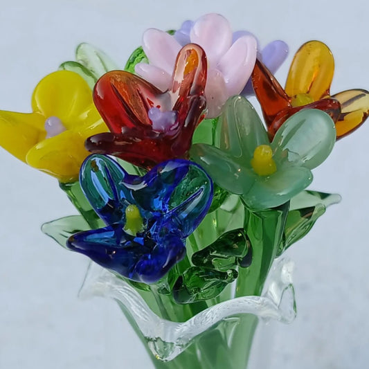Close-up of colorful miniature glass flowers arranged in a vase, highlighting detailed lampwork craftsmanship